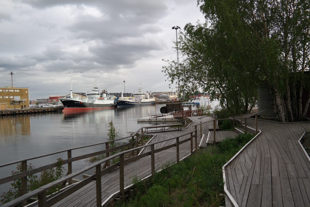 A path-way to the pool and some ships in the harbor.